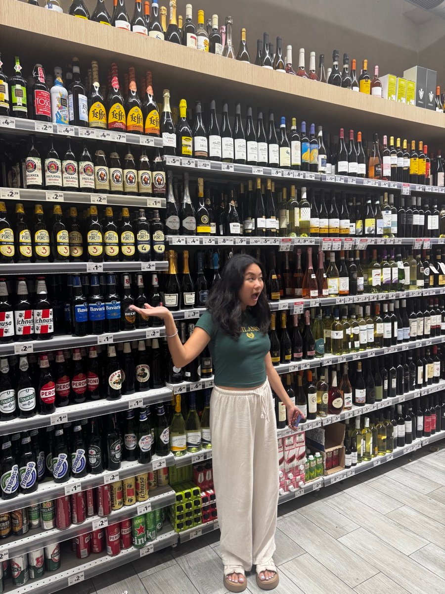 Alyssa in the wine and beer aisle of a supermarket in Bologna