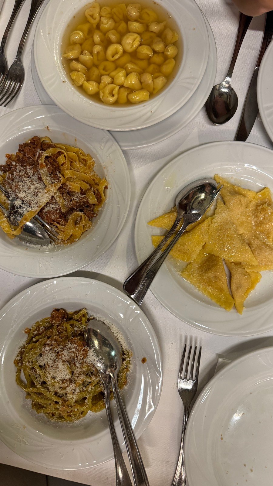 A spread of fresh pasta dishes at Da Cesari trattoria in Bologna, including tortellini and tagliatelle al ragu