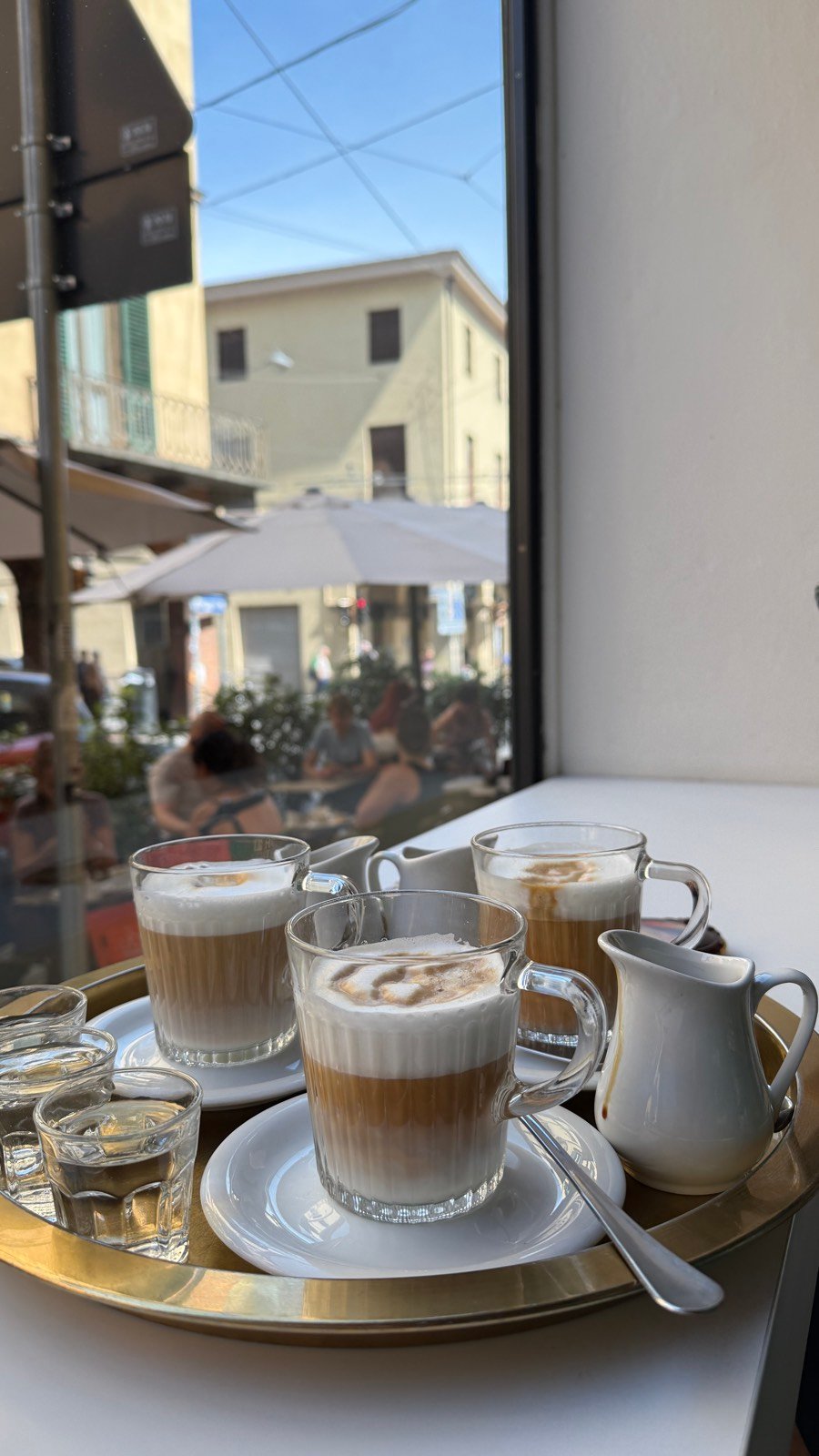 A tray of cappuccinos by the window at Lampadina brunch spot in Bologna