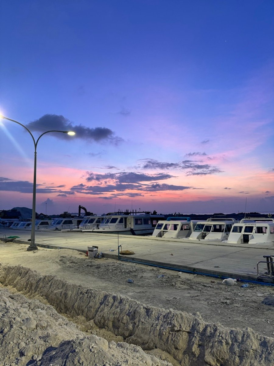 A pink and purple sunset over the speedboat harbour on Maafushi