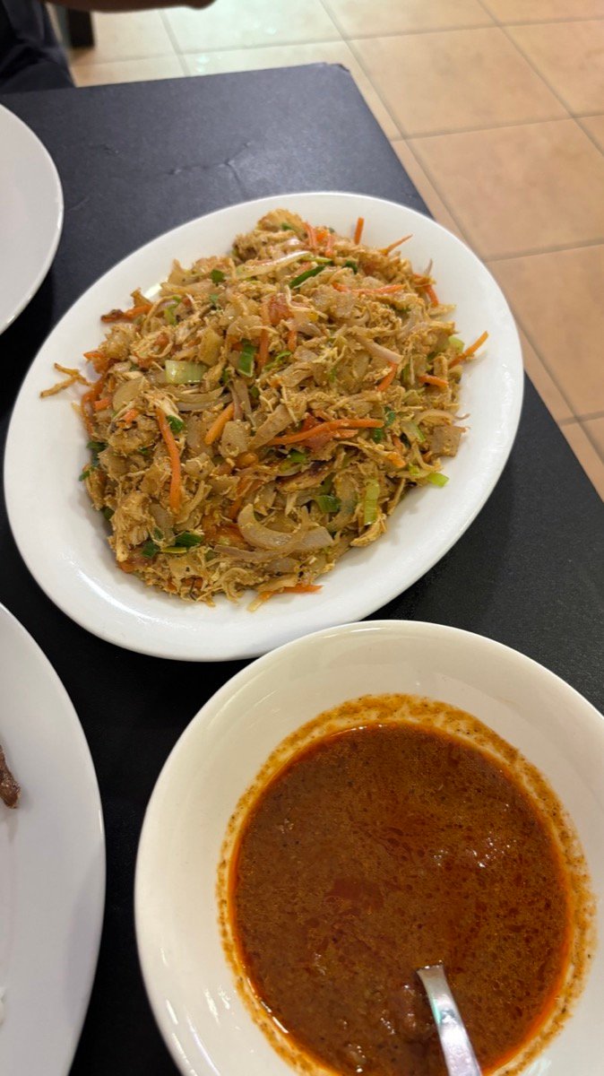 A plate of Sri Lankan kottu with a bowl of curry at Machan Maldives in Male