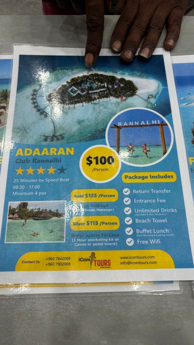 A resort day trip flyer listing a US$120 per person package with speedboat transfer, buffet lunch and unlimited drinks