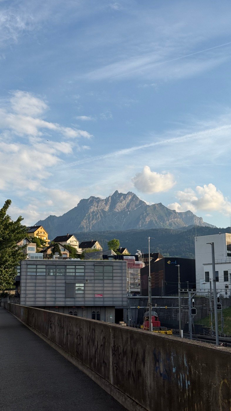 Mount Pilatus rising above the rooftops of Kriens near Lucerne at golden hour