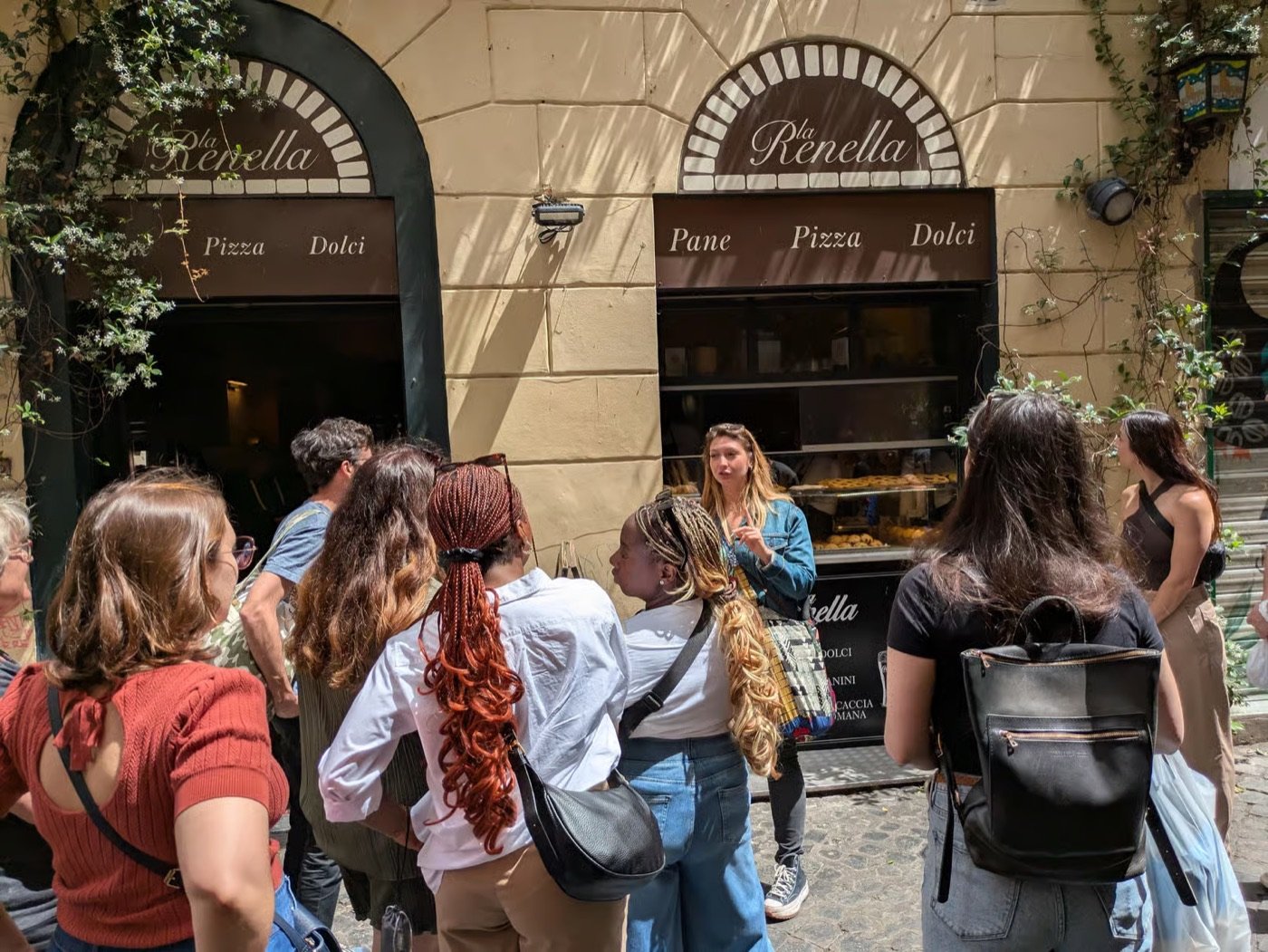 A guided food tour group outside La Renella bakery in Trastevere, Rome