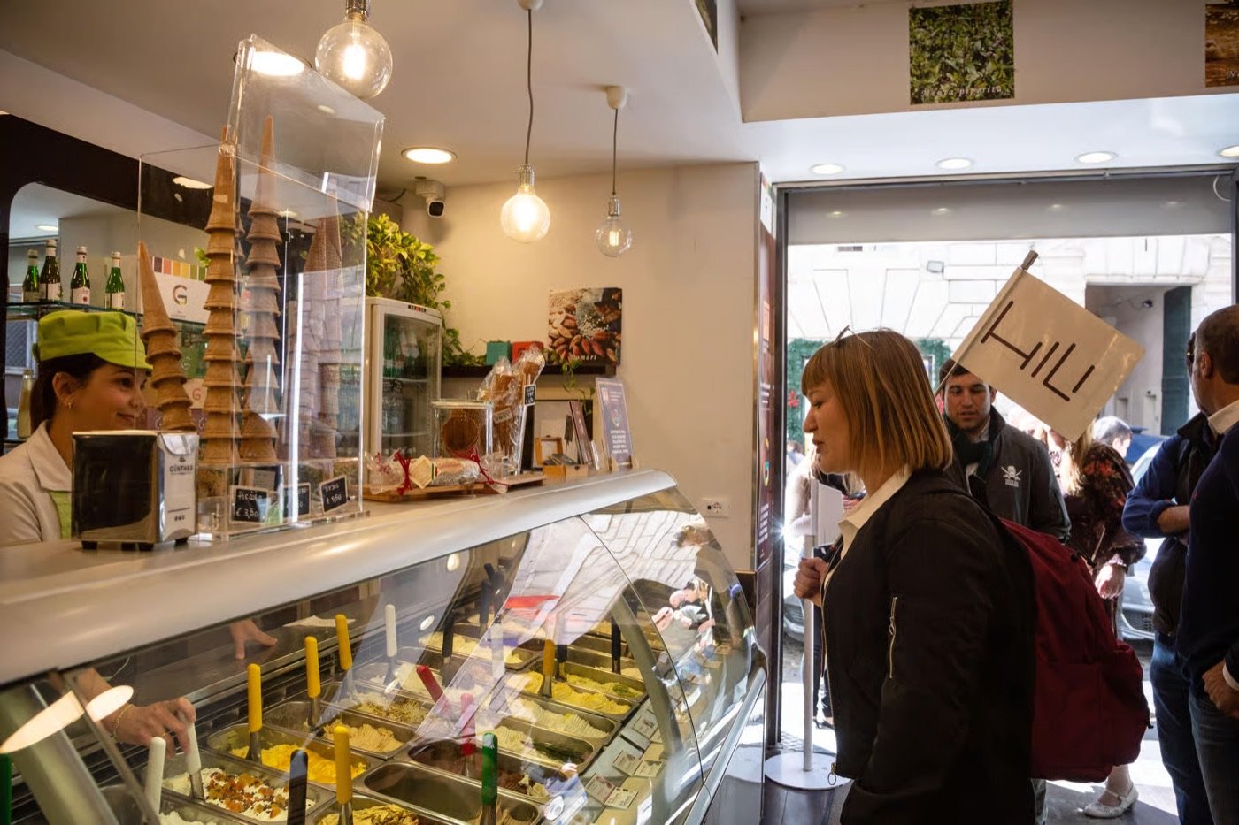 A food tour group at a gelateria counter in Rome