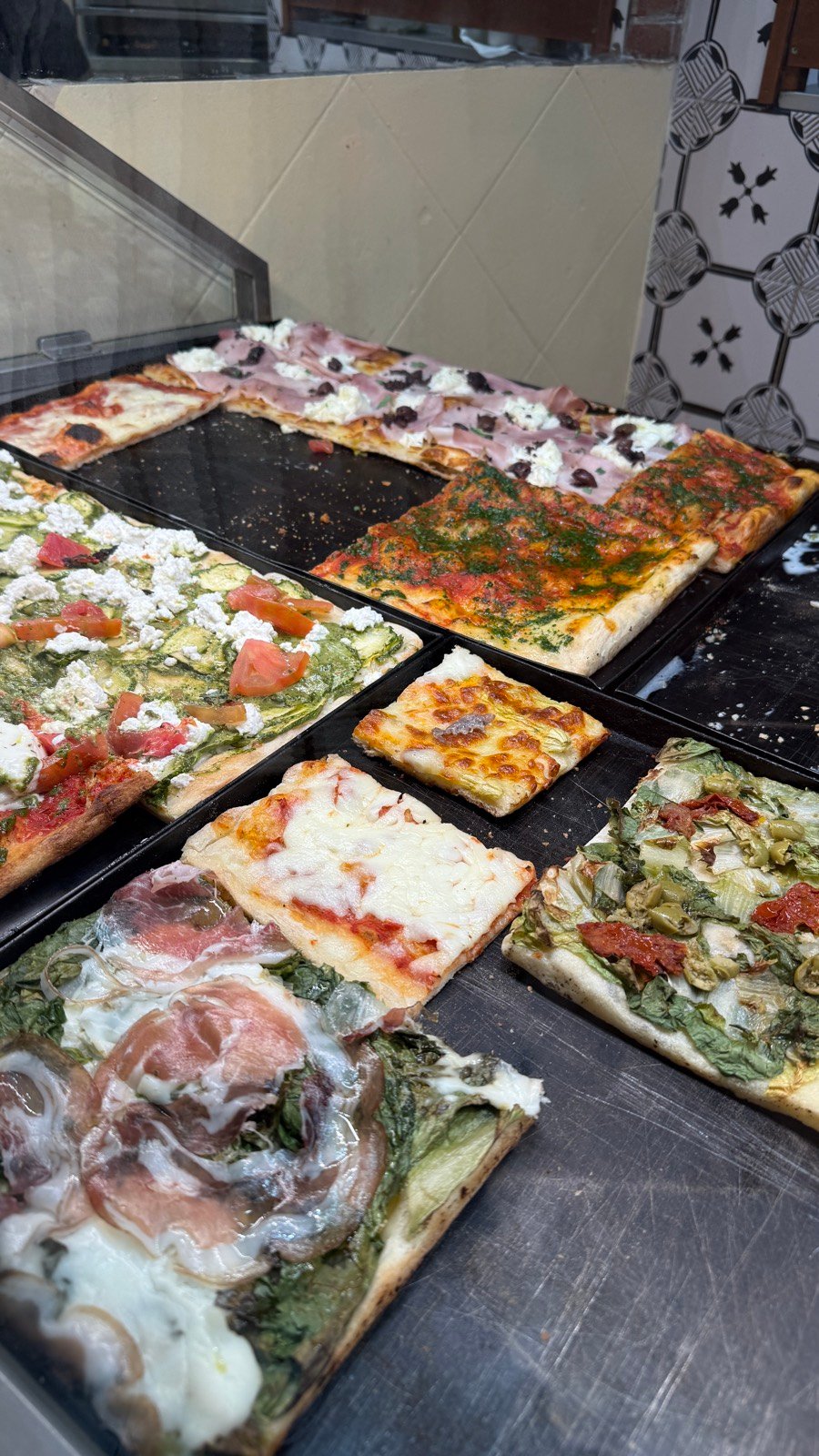 Pizza al taglio slices at La Boccaccia in Trastevere, Rome