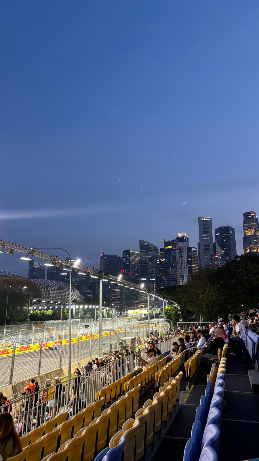Night view of the lit Marina Bay Street Circuit and Singapore skyline from the Stamford grandstand
